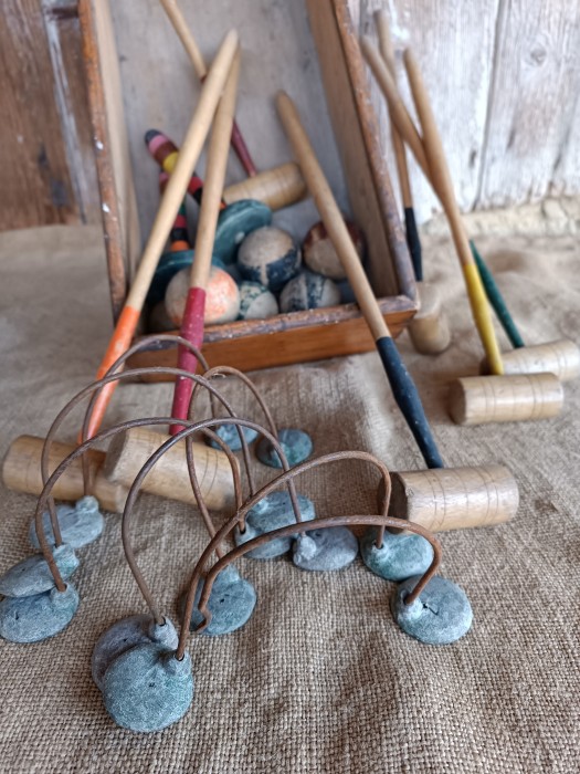 French Brocante - For Sale - Vintage Play Worn Indoor Croquet Set Description: <p>Early 1900's vintage French indoor or table croquet set complete with all the 6 mallets, six balls, hoops and two pins. The mallets measure 37cm long</p>

<p>It has a good play worn look making it perfect for a vintage display as well as for playing with</p>

<p>Issues - one of the hoops has lost a foot, it could be replaced with wood or a moulded plaster foot to match and the box lid is missing </p>
