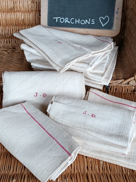 French Brocante - For Sale - Classic French Hemp Linen Torchon Cloth, WovenDescription: <p>The iconic French rustic homespun torchon with a woven red stripe at each end and a small cross stitch initial JD hand embroidered on each. These are a superb floppy nubby hemp, worn in feel but in good condition</p>

<p>There are 9 available, the price is for one cloth only</p>

<p>Measurements 105cm by 62cm</p>

<p>They have been used, they have all been laundered and are now clean, a couple have small issues, one a mark that remained and one a inky line stain</p>
