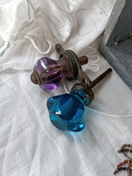 French Brocante - For Sale - Two Solid Crystal KnobsDescription: <p>Quite a bit of damage to these faceted glass door knobs but the gorgeous amethyst and sapphire colours make up for it</p>

<p>I'm thinking repurpose into light or curtain pulls, or hang in the window for decoration</p>

<p> </p>
