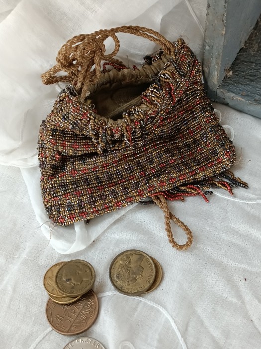 French Brocante - For Sale - Tiny Metal Beaded Aumoniere, Change PurseDescription: <p>A pretty antique aumoniere purse with drawstring top lined with satin</p>

<p>The beads are metal in shades of gold, red, and steel</p>

<p>There is some damage and small loss of beads particularly on the bottom fringe, a little work will be needed stabilise it</p>

<p> </p>
