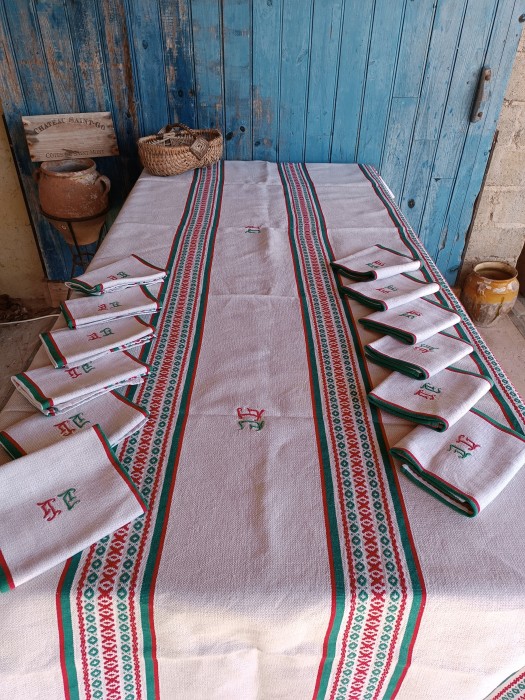 French Brocante - For Sale - Vintage Basque Stripe Tablecloth and Napkin Set Description: <p>Fabulous vintage 1920's/30's striped Basque table linen set, made in the traditional diamond weave of these regional textiles</p>

<p>This is a particularly heavy and excellent quality set, the red and green decoration is woven into the fabric not printed and has the feel of embroidery, the cloth is probably a linen and cotton blend</p>

<p>The tablecloth and each of the 12 napkins are hand embroidered with what I think is a DG monogram, it's quite stylised so hard to tell, sewn in matching green and red</p>

<p>Cloth 252cm by 132cm, napkins 57cm by 42cm</p>

<p>I have laundered this set and it is in excellent condition ready to use</p>
