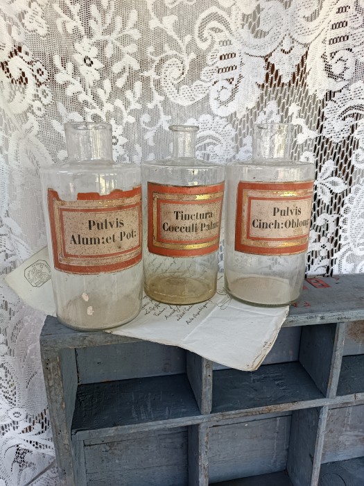 French Brocante - For Sale - Set of Three Hand Blown Pharmacy JarsDescription: <p>Three clear glass pharmacy jars with their original labels, the glass is hand blown with many beautiful inclusions adding lots of character and a pontil mark on the base of each.</p>

<p>The original labels are paper with gilt borders, there's some age related discolouration to the paper</p>

<p>They have been cleaned on the outside but not inside, depending on the look you are after we can clean before sending or leave as found for props use</p>

<p>20cm high</p>

<p>No chips or cracks to the glass, Price is for all three</p>
