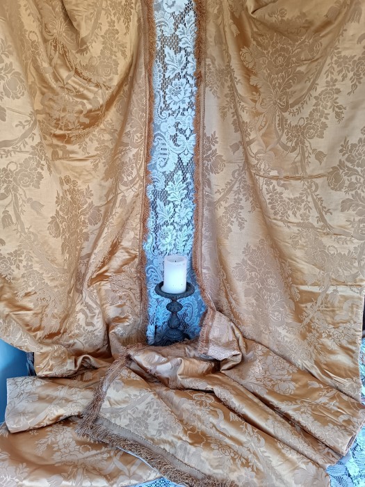 French Brocante - For Sale - Chateau Antique Silk & Cotton Brocade DrapesDescription: <p>From a chateau in central France this is a stunning pair of gold silk and cotton brocade curtains which would have dressed the sides of the French windows with a lighter muslin or lace curtain at the centre hence the long narrow shape </p>

<p>The shimmer of the silk and the bright gold colour are sumptuous and the brocade pattern of bows, cords, flower garlands and sprays are perfect chateau chic</p>

<p>They are fully lined with a wool felt for insulation....it can get pretty draughty in a massive chateau....and over that a beige glazed cotton, they also have their original large antique brass rings attached for hanging</p>

<p>Dating from the early 20thc they are in surprisingly good condition, a little damp staining on the lining probably from touching the window, the silk is in good order, a slight beginning of shattering on the side of one curtain where it has had a long exposure to light, they also have that old fabric smell and need an airing</p>

<p>Each curtain measures 106" by 24", 270cm by 61cm not including the fringe</p>

<p> </p>
