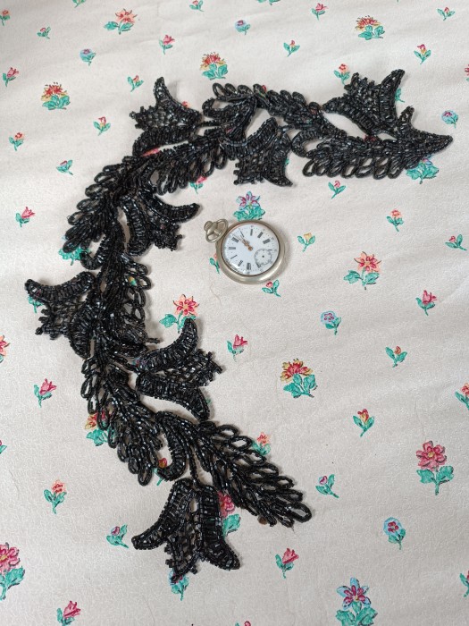 French Brocante - For Sale - Large Jet Leaf Shape Dress EmbellishmentDescription: <p>Large motifs of flowers and leaves make up this long applique dress embellishment, it is in good condition with no losses</p>

<p>Measures 59cm long</p>
