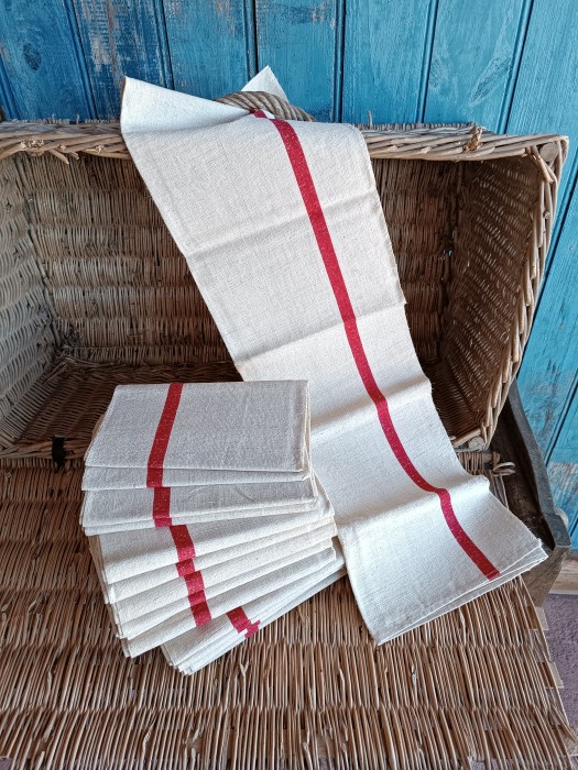 French Brocante - For Sale - Antique Farmhouse Hemp Kitchen Torchons Description: <p>Part of a wonderful haul of unused farmhouse heirloom cloths all from the same vide maison, these twelve torchons are a classic utilitarian style for multiple uses so have no initials, made from a thick weave hemp fabric with a wide red stripe running down both sides.</p>

<p>They are a light oatmeal colour with that natural rustic homespun look, dotted with flecks of hemp. As they have never been used I have chosen to leave them in their straight from the armoir condition and they will need a launder before use, the discolouration is where they have been folded and exposed and washes out easily.</p>

<p>6 SOLD, 6 still available</p>

<p>Measure 78cm by 60cm </p>
