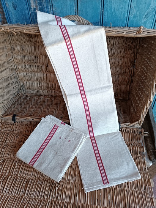 French Brocante - For Sale - Antique Farmhouse Hemp Kitchen Torchons, 4 stripe Description: <p>Part of a wonderful haul of unused farmhouse heirloom cloths all from the same vide maison, these two torchons are a classic utilitarian style for multiple uses, made from a rustic weave hemp fabric with a combination of two wide red stripes and two narrow running down both sides.</p>

<p>They each have AB initials and a hanging tag, they are a light oatmeal colour with that natural rustic homespun look, dotted with flecks of fibres. As they have never been used I have chosen to leave them in their straight from the armoire condition and they will need a launder before use, the discolouration is where they have been folded and exposed and washes out easily.</p>

<p>Measure 75cm by 59cm </p>
