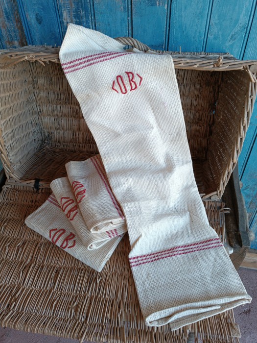 French Brocante - For Sale - Antique Farmhouse Kitchen Torchons, Waffle Style Description: <p>Part of a wonderful haul of unused farmhouse heirloom cloths all from the same vide maison, these four torchons have a unique soft waffle honeycomb texture which makes them very absorbent.</p>

<p>Each one has been hand embroidered with her OB initials in high relief, other details include a band of drawnthread work decoration at each end by the hem and a traditional woven in three stripe pattern at each end.</p>

<p>They are an oatmeal colour with that natural rustic homespun look. As they have never been used I have chosen to leave them in their straight from the armoir condition and they will need a launder before use, the discolouration is where they have been folded and exposed and washes out easily.</p>

<p>Measure 79cm by 58cm </p>

<p> </p>
