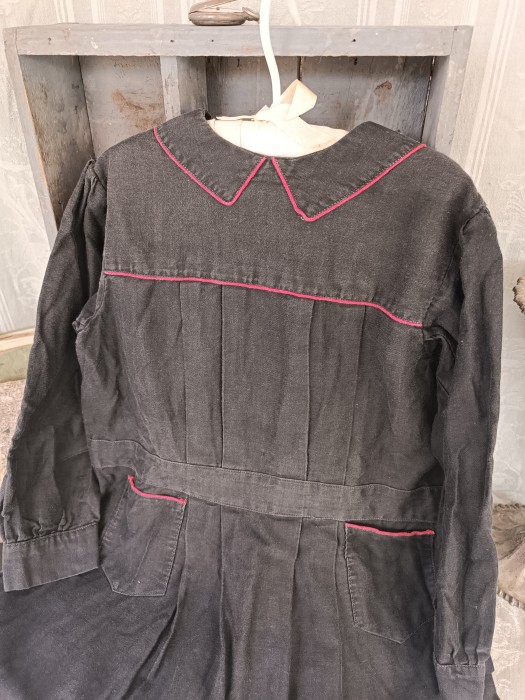 French Brocante - For Sale - Cute 1910's Child's Pinafore Dress Description: <p>Circa 1910 very cute vintage school pinafore in&nbsp;soft faded black cotton with delightful red piping, in good wearable condition, not laundered, chest 28"</p>

<p>&nbsp;</p>
