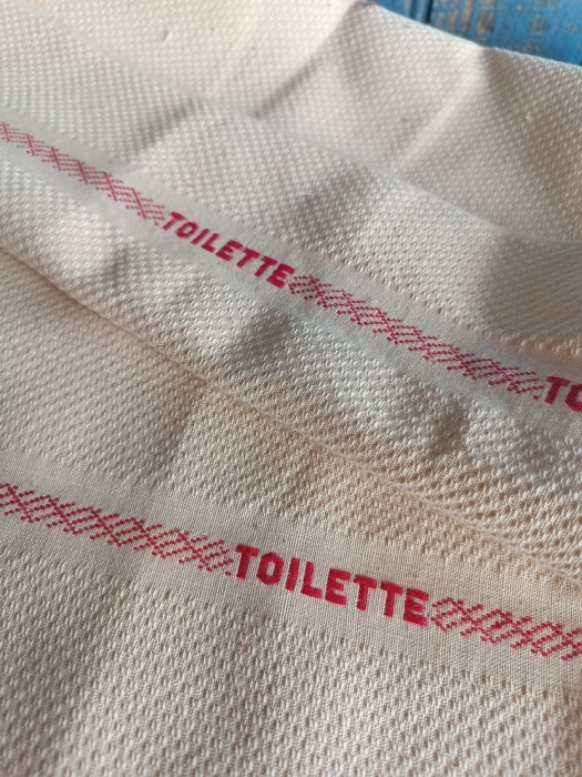 French Brocante - For Sale - 1 Meter of Serviette de Toilette Fabric Description: <p>Sold to make wash towels with, I have never seen this fabric with lettering incorporated into that red stripe, the basket weave texture is beautiful, it has a coolness but from the feel I think most likely a cotton and linen blend, as new dead stock, so perfect condition, of course impossible to measure the bolt so we have cut a meter and worked out from weight that there was probably 60 meters in the bolt, I will sell by the meter which gives you a piece with approximately 8 of the words Toilette on each side, width is 59cm</p>
