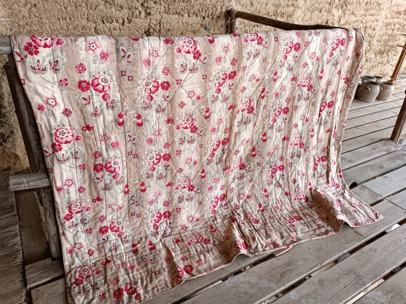 French Brocante - For Sale - 19th Century Whole Cloth Quilt, Double SidedDescription: <p>A hand stitched 19th century quilt with a diamond pattern centre and narrow bands of stitching on the four sides to create a border.</p>

<p>The same fabric has been used on both sides of the quilt, a soft weave cotton decorated with vibrant pink blooms shaded with green and wine red and bands of ombre shading, there are approximately two and a half loom widths on each side</p>

<p>Filled with a thick layer of batting which is still flat and evenly spread</p>

<p>It's larger size would make it suitable for a modern bed, 228cm by 200cm, 90" by 79"</p>

<p>Condition is very good for an antique quilt, it is left as found and cleaning is recommended before use, no major holes, overall it looks clean, only one very faint pale brown mark on one side,  </p>

<p>I can arrange cleaning for an additional €25-€35</p>

<p> </p>

<p> </p>
