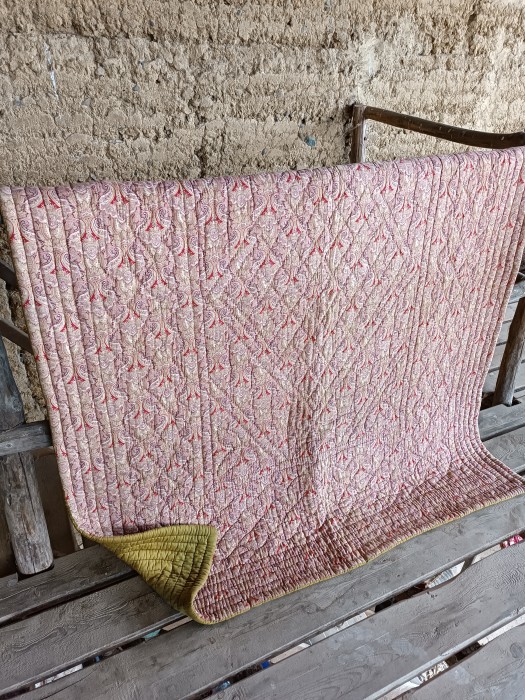 French Brocante - For Sale - Antique 19th Century Whole Cloth Quilt, Hand SewnDescription: <p> An exceptional hand stitched 19th century quilt with a dense diamond pattern centre, a second loop stitch border around the centre panel and narrow bands of stitching on the four sides to create an outer border.</p>

<p>The fabric used on one side of the quilt is a beautiful pink Paisley with red highlights, an intense pattern, on the other side a wonderful olive green, there are approximately two and a half loom widths on each side</p>

<p>Filled with a thick layer of batting which is flat and still evenly spread</p>

<p>Medium size, suitable for a bed or throw, 187cm by 200cm, 74" by 57"</p>

<p>Condition is very good for an antique quilt, it is left as found and cleaning is recommended before use, no major holes, overall it looks clean, only one very faint pale brown mark on one side,  </p>

<p>I can arrange cleaning for an additional €25-€35</p>
