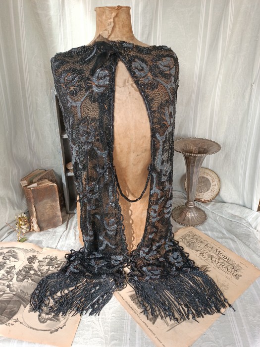 French Brocante - For Sale - Pair of Early 1900's Jet Bead Dress Appliqués Description: <p>These superb dress embellishments are huge, I had&nbsp;some difficulty working out how they were arranged so I hope the photos do them justice as they are magnificent&nbsp;</p>

<p>The main sections are made from a tulle decorated with glass seed and barrel beads, which have a grey hue, to create the pattern,&nbsp;there's a beaded loop edging running both side of each appliqu&eacute;, both are finished with long heavy beaded fringing the strands interspersed with faceted beads.</p>

<p>The panels are linked with two long strands of beadwork that possibly would have draped around the back of the dress, with a thicker band that joins them at the front, or it may have been one panel mounted on the front and one on the back and the strands draping each side to link the two, well that's my guess</p>

<p>It has a look of a flapper piece but the materials suggest much older, more like 1900</p>

<p>The quality and condition of this striking confection is excellent, an&nbsp;original gem perfect for recreating a showstopping vintage costume&nbsp;</p>
