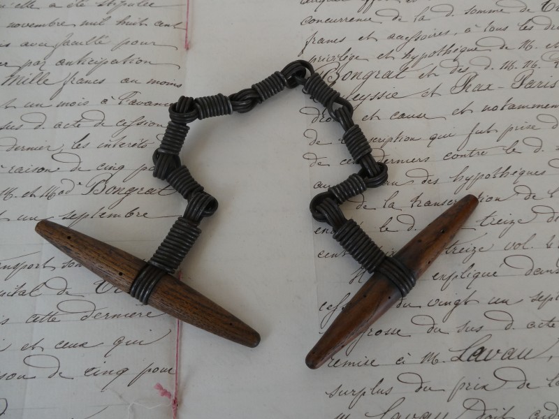 French Brocante - For Sale - Antique Gendarme French Police Restraining Cuff Description: <p>Antique chain link handcuffs or wrist restraint known as a 'Cabriolet' used by the french Gendarmes right up until the latter part of the last century</p>

<p>The twisted wire wraps around the wrist and the officer twists the two wooden handles to lead the prisoner away</p>

<p>Definitely one for the curiosity cabinet</p>

<p>Good clean condition</p>
