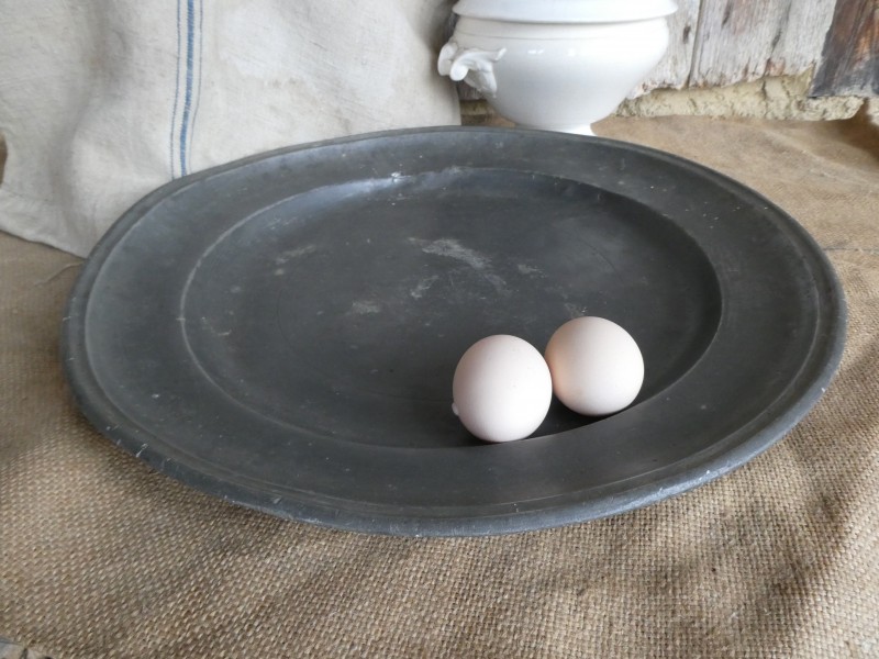 French Brocante - For Sale - Large Farmhouse Pewter ChargerDescription: <p>This huge chunky pewter charger dating from the 19th century is a beauty, a fabulous French farmhouse staple showing all its history in its patina, dings and scratches, it would make a fabulous serving dish, cheese board or period touch to a country style décor</p>

<p>Fantastic dark antique patina as it is, but could be polished if you prefer a more silver look</p>

<p>17" diameter</p>
