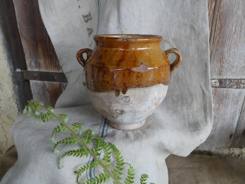 French Brocante - For Sale - Antique 19th Century Confit PotDescription: <p>With its unusual dark toffee speckled glaze and a slightly different shape from normal this lovely antique confit pot will make a interesting addition to a collection or look fabulous as part of a country kitchen display</p>

<p>It is timeworn which is how we prefer our confit pots to look, if pristine these utilitarian pots have less character, there are chips in the glaze around the rim and a ding in part of the shoulder and a small fine hairline crack but all part of its history, still solid and useable</p>

<p>8.5"/22cm high</p>
